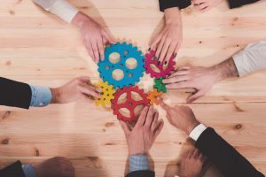 Procurement service people's hands with cogs and gears